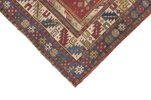 Backside of handmade 1900s Kazak rug showing knot structure and weave density