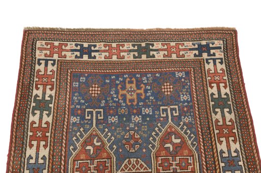 Surface texture of 1900s Kazak rug with natural Wool and intricate pattern