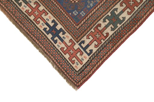 Backside of handmade 1900s Kazak rug showing knot structure and weave density