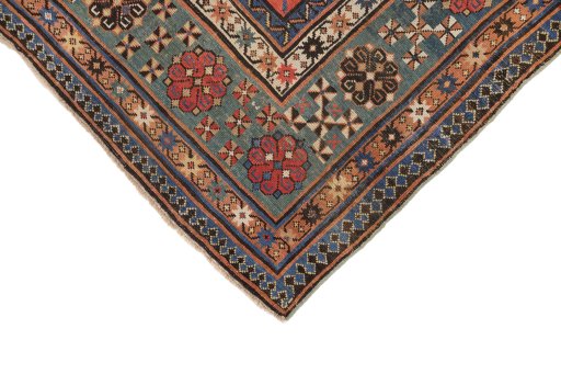 Backside of handmade 1900s Kazak rug showing knot structure and weave density