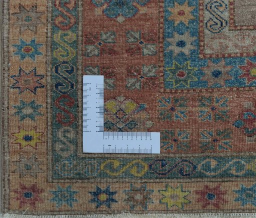 Corner detail of New Kazak rug showing border pattern and Wool pile