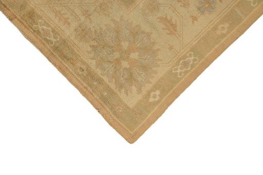 Backside of handmade 1920s Oushak rug showing knot structure and weave density