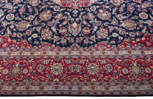 Corner detail of 2000s Kashan rug showing border pattern and Cork pile