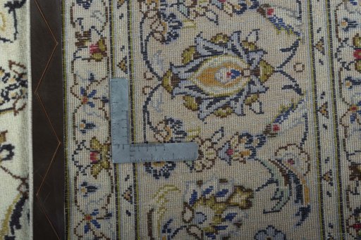 Backside of handmade 2000s Kashan rug showing knot structure and weave density