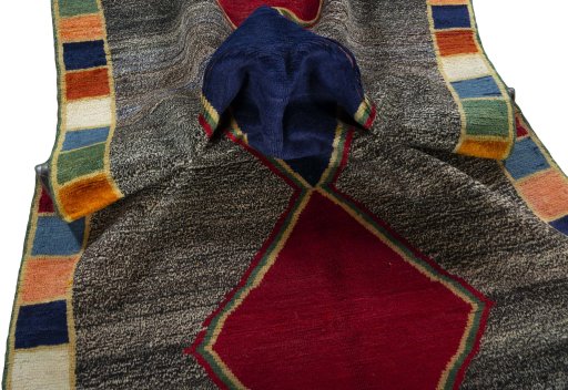 Corner detail of 1970s Persian Gabbeh rug showing border pattern and Wool pile