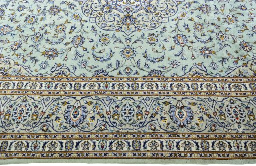 Corner detail of 2000s Kashan rug showing border pattern and Wool pile