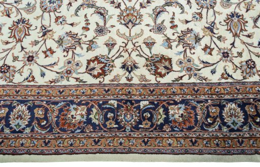 Corner detail of 2000s Mashad rug showing border pattern and Wool pile