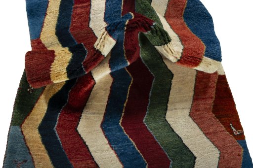 Corner detail of 2000s Persian Gabbeh rug showing border pattern and Wool pile