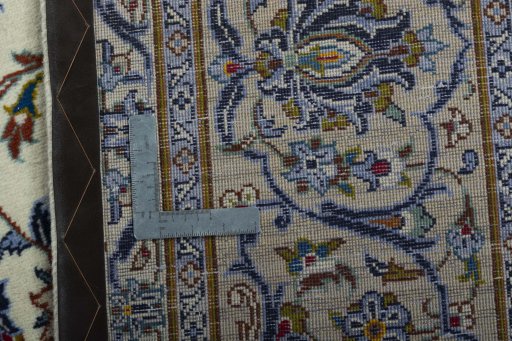 Backside of handmade 2000s Kashan rug showing knot structure and weave density