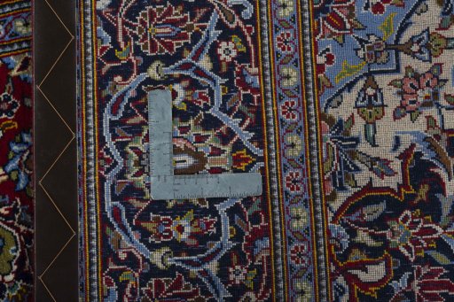 Backside of handmade 2000s Kashan rug showing knot structure and weave density
