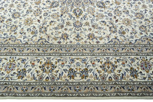 Corner detail of 2000s Kashan rug showing border pattern and Wool pile