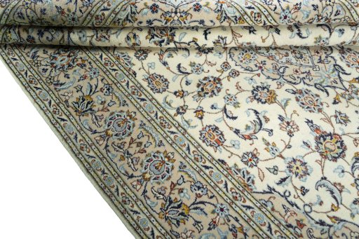 Corner detail of 2000s Kashan rug showing border pattern and Wool pile