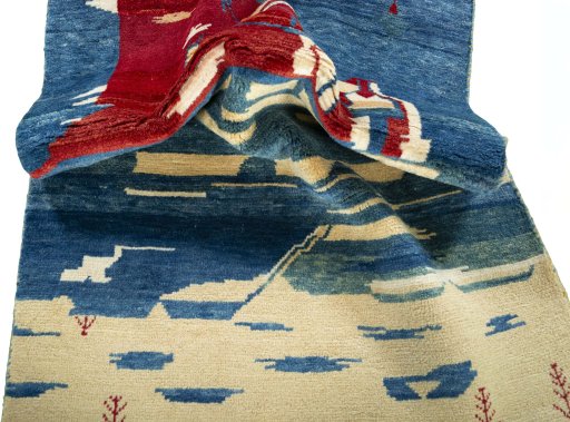 Corner detail of 2000s Persian Gabbeh rug showing border pattern and Wool pile