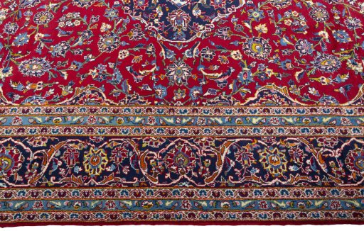 Corner detail of 2000s Kashan rug showing border pattern and Wool pile