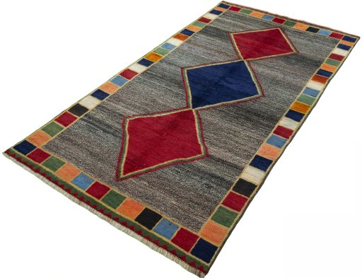 Corner detail of 1970s Persian Gabbeh rug showing border pattern and Wool pile