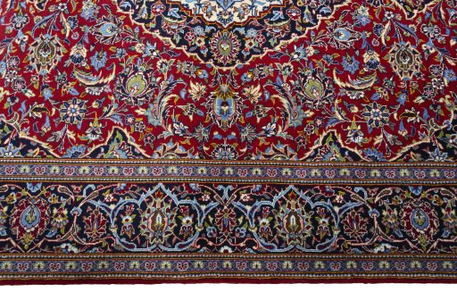 Corner detail of New Kashan rug showing border pattern and Cork pile