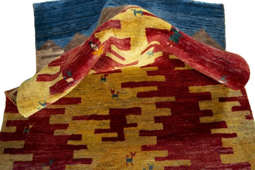 Corner detail of 2000s Persian Gabbeh rug showing border pattern and Wool pile