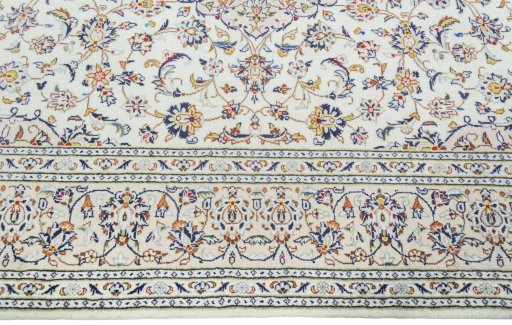 Corner detail of 2000s Kashan rug showing border pattern and Wool pile