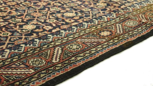 Backside of handmade 2000s Farahan rug showing knot structure and weave density
