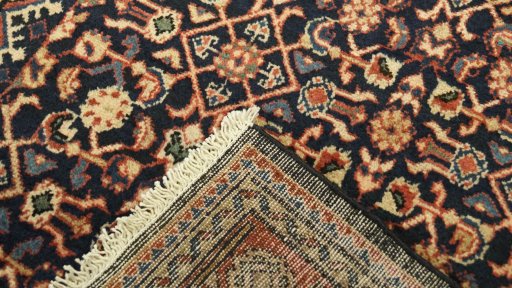 Close-up detail of 2000s Farahan rug from Iran / Persia showing Wool weave