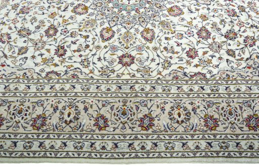 Corner detail of 2000s Kashan rug showing border pattern and Wool pile