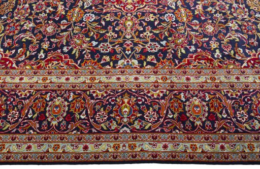 Corner detail of 2000s Kashan rug showing border pattern and Wool pile