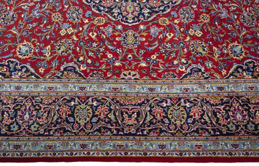 Corner detail of New Kashan rug showing border pattern and Cork pile