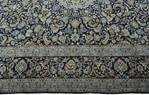 Corner detail of New Kashan rug showing border pattern and Cork pile