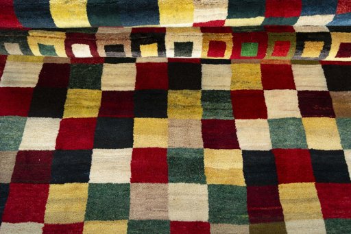 Full view of 2000s Persian Gabbeh rug from Pakistan, 226 × 153 cm in Multi Color tones