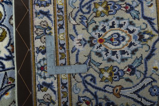 Backside of handmade 2000s Kashan rug showing knot structure and weave density