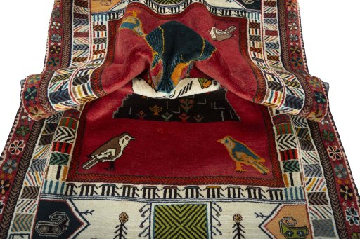 Corner detail of 2000s Persian Gabbeh rug showing border pattern and Wool pile