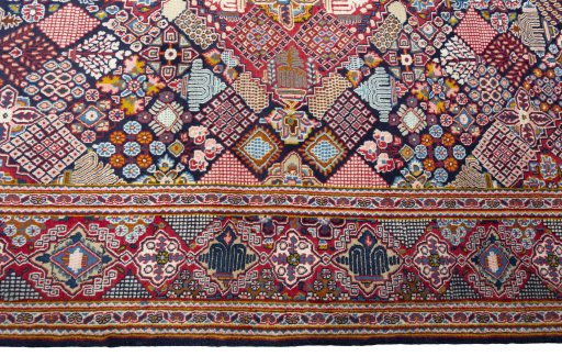 Corner detail of 2000s Kashan rug showing border pattern and Wool pile