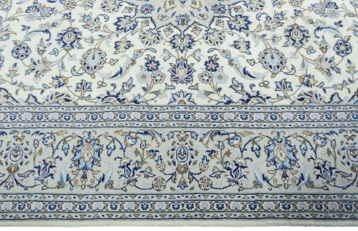 Corner detail of 2000s Kashan rug showing border pattern and Wool pile