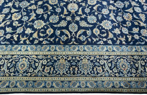 Corner detail of 2000s Kashan rug showing border pattern and Wool pile