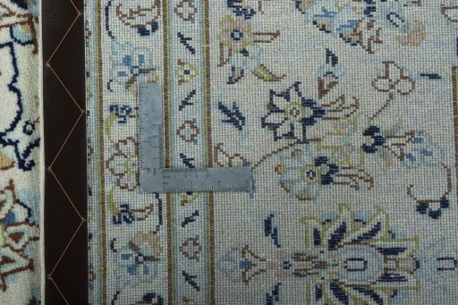 Backside of handmade New Kashan rug showing knot structure and weave density