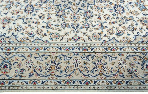 Corner detail of 2000s Kashan rug showing border pattern and Wool pile