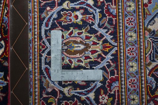 Backside of handmade New Kashan rug showing knot structure and weave density