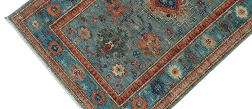 Backside of handmade New Kazak rug showing knot structure and weave density