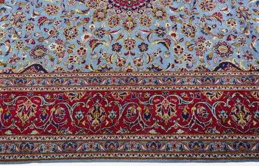 Corner detail of 2000s Kashan rug showing border pattern and Wool pile