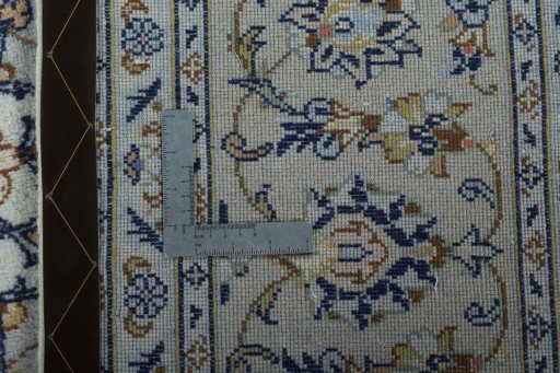 Backside of handmade New Kashan rug showing knot structure and weave density