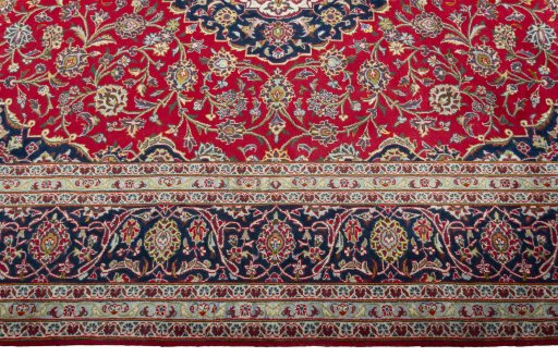 Corner detail of 2000s Kashan rug showing border pattern and Wool pile