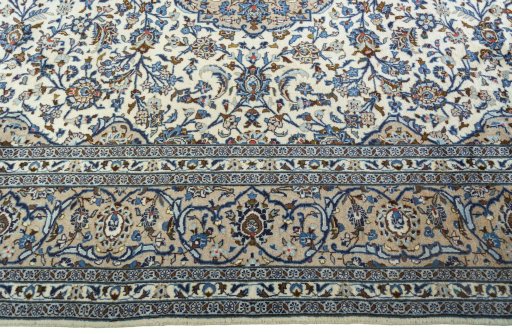 Corner detail of 2000s Kashan rug showing border pattern and Wool pile