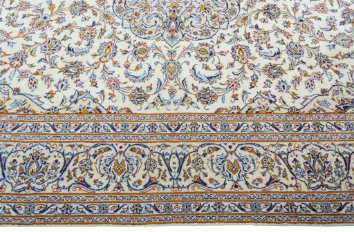 Corner detail of 2000s Kashan rug showing border pattern and Wool pile