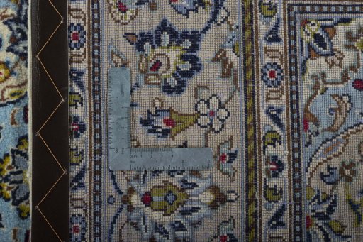 Backside of handmade 2000s Kashan rug showing knot structure and weave density