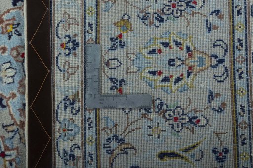 Backside of handmade 2000s Kashan rug showing knot structure and weave density