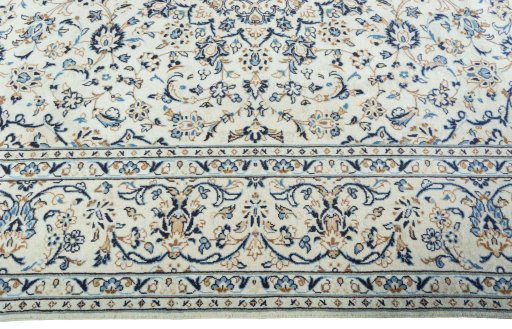 Corner detail of 2000s Kashan rug showing border pattern and Wool pile