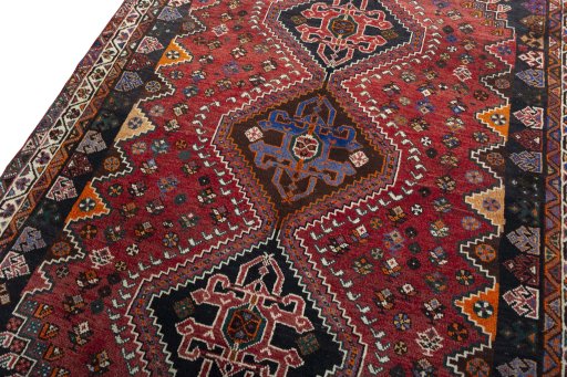 Backside of handmade 2000s Shiraz rug showing knot structure and weave density