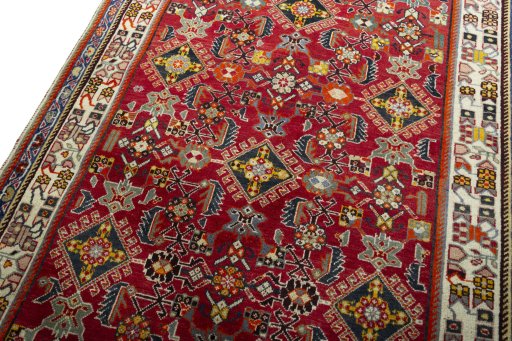 Backside of handmade 2000s Shiraz rug showing knot structure and weave density