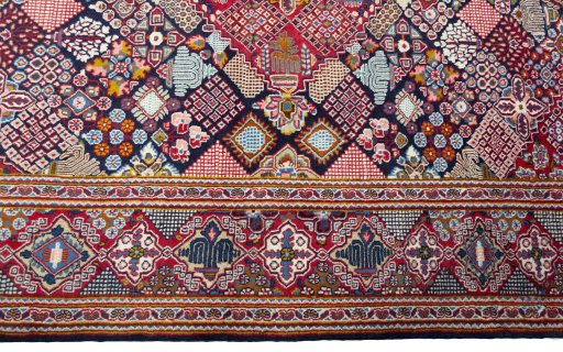 Corner detail of 2000s Kashan rug showing border pattern and Wool pile