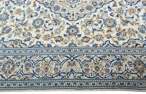 Corner detail of 2000s Kashan rug showing border pattern and Wool pile
